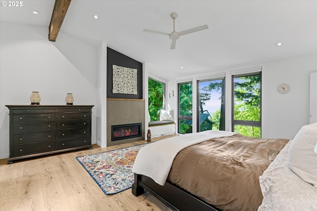 1801 NW Walmer Dr, Portland, OR 97229 - bedroom with light wood-style floors, a glass covered fireplace, recessed lighting, and ceiling fan
