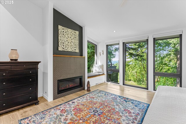 1801 NW Walmer Dr, Portland, OR 97229 - bedroom featuring wood finished floors and a glass covered fireplace