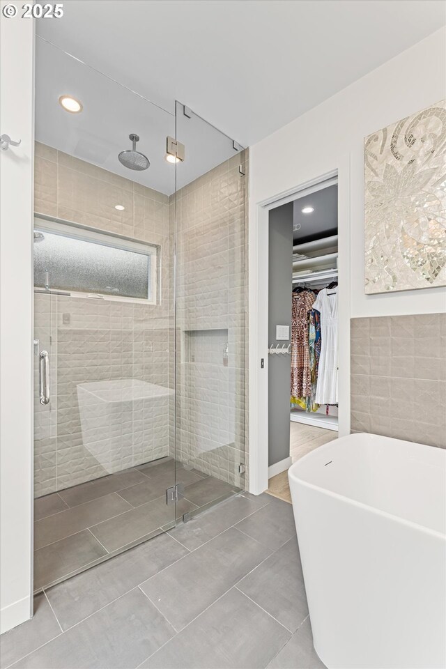 1801 NW Walmer Dr, Portland, OR 97229 - bathroom with a stall shower, a spacious closet, a freestanding tub, tile patterned floors, and recessed lighting