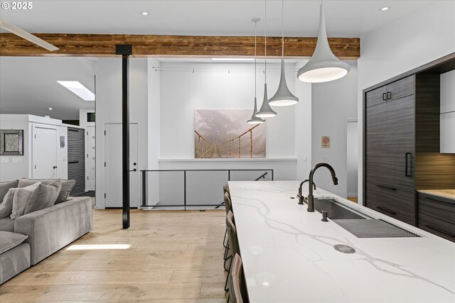1801 NW Walmer Dr, Portland, OR 97229 - kitchen featuring light wood-type flooring, light stone countertops, pendant lighting, recessed lighting, and open floor plan