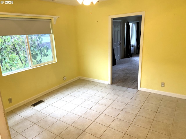 tiled empty room with ceiling fan