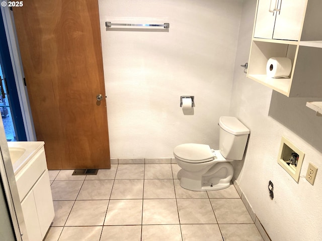 bathroom featuring tile patterned floors, vanity, and toilet