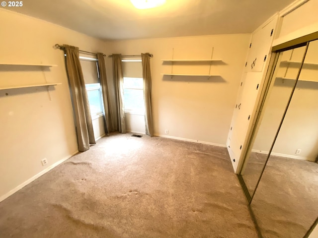 unfurnished bedroom featuring a closet and carpet floors