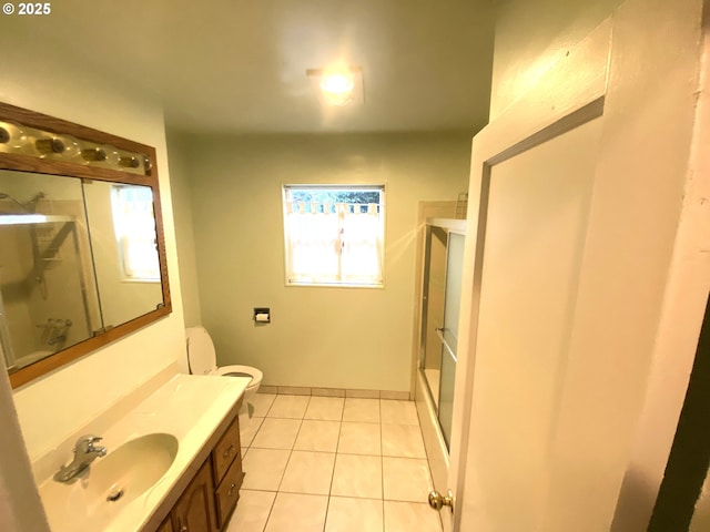 bathroom featuring a wealth of natural light, tile patterned flooring, vanity, and walk in shower