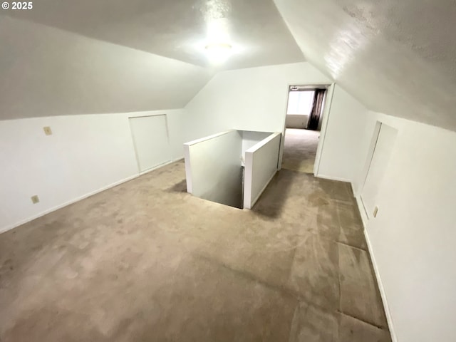 bonus room with carpet flooring and lofted ceiling