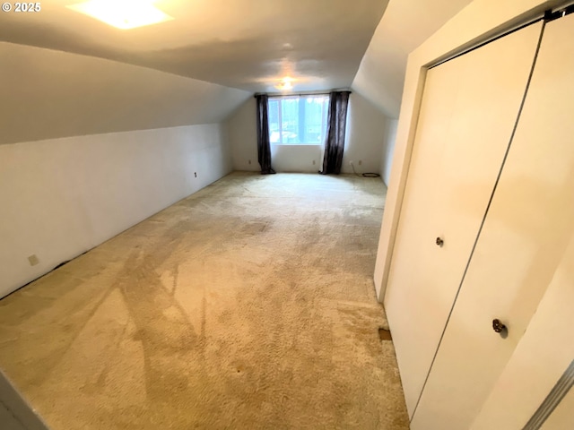 bonus room featuring light colored carpet and lofted ceiling