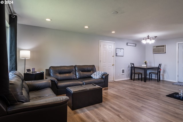 living room featuring wood-type flooring and an AC wall unit