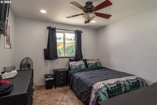 bedroom featuring ceiling fan and light carpet