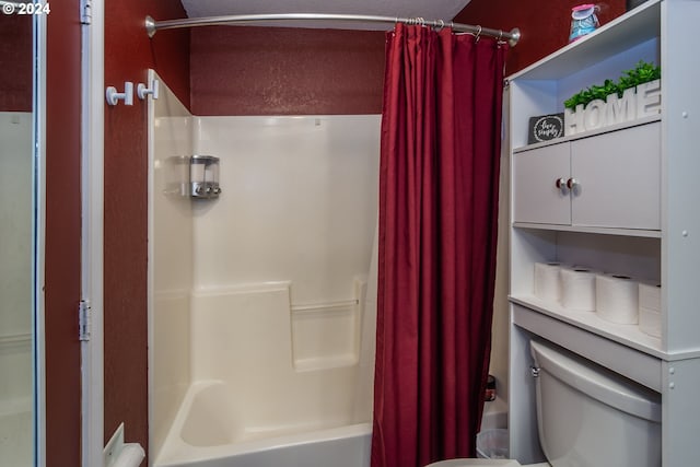 bathroom featuring shower / bath combo and toilet