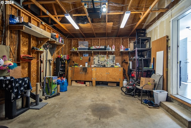 garage featuring a workshop area and a garage door opener