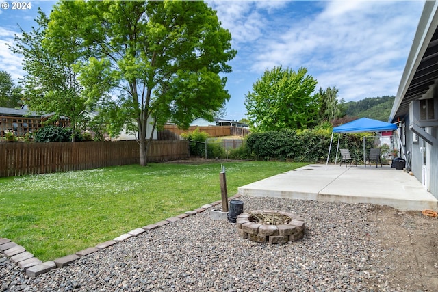 view of yard with a patio area and a fire pit