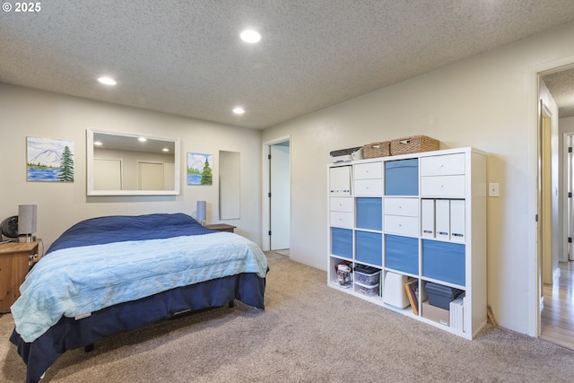 carpeted bedroom featuring a textured ceiling