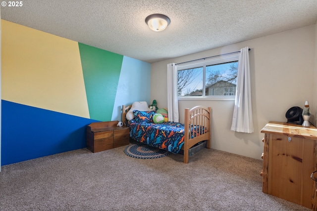 bedroom featuring light carpet and a textured ceiling