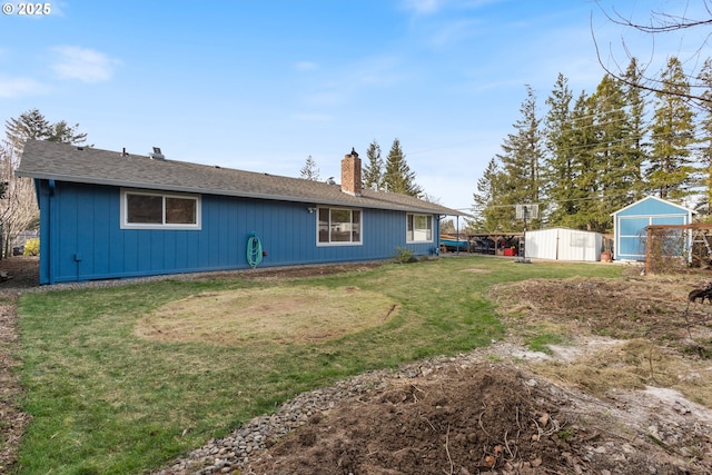 rear view of house featuring a shed and a lawn