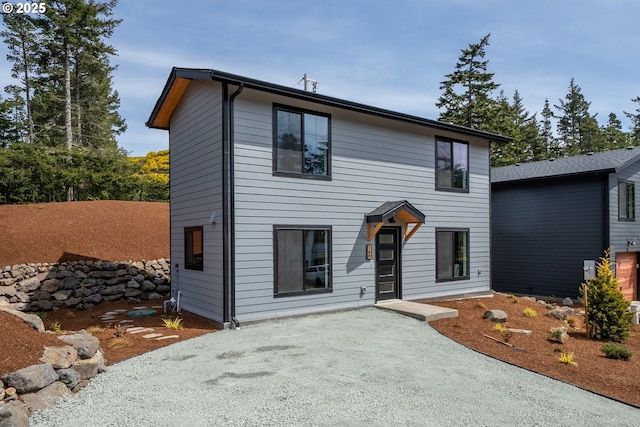 contemporary home with a patio area and driveway