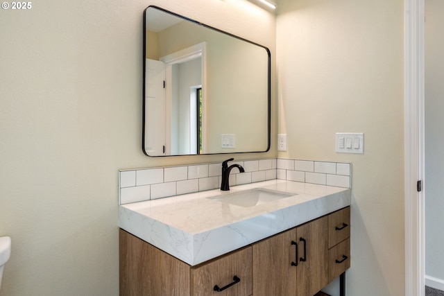 bathroom with vanity and backsplash