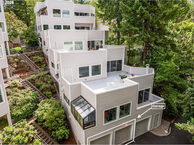 48 Eagle Crest Dr Unit 3D, Lake Oswego, OR 97035 - back of house with an attached garage, view of scattered trees, and a balcony