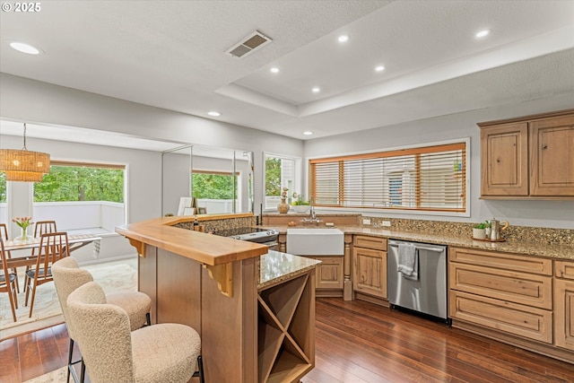 48 Eagle Crest Dr Unit 3D, Lake Oswego, OR 97035 - kitchen with dishwasher, dark wood-style flooring, recessed lighting, a breakfast bar area, and light stone counters