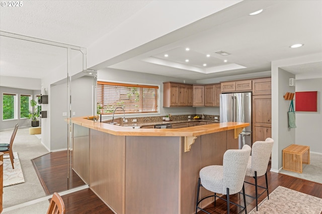 48 Eagle Crest Dr Unit 3D, Lake Oswego, OR 97035 - kitchen with stainless steel appliances, butcher block countertops, dark wood-style flooring, a kitchen breakfast bar, and recessed lighting
