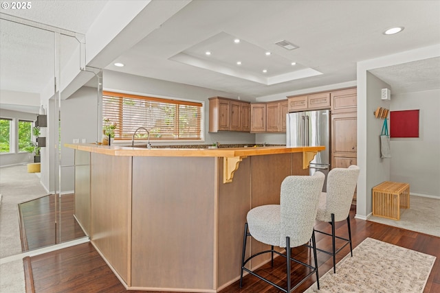 48 Eagle Crest Dr Unit 3D, Lake Oswego, OR 97035 - kitchen with freestanding refrigerator, wooden counters, dark wood-style floors, recessed lighting, and a breakfast bar area