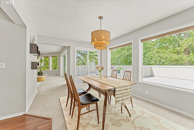 48 Eagle Crest Dr Unit 3D, Lake Oswego, OR 97035 - dining area featuring light carpet, healthy amount of natural light, a textured ceiling, and a chandelier