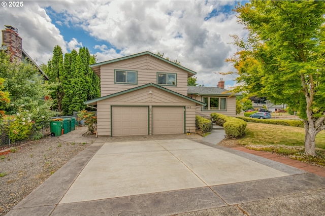 642 SW Cherry Park Rd, Troutdale, OR 97060 - split level home featuring a garage, concrete driveway, and a chimney