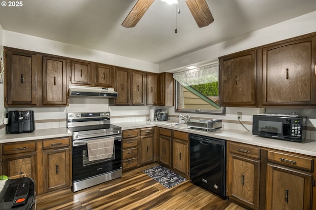 642 SW Cherry Park Rd, Troutdale, OR 97060 - kitchen with black appliances, under cabinet range hood, dark wood finished floors, a ceiling fan, and light countertops