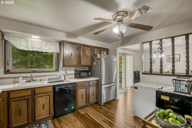 642 SW Cherry Park Rd, Troutdale, OR 97060 - kitchen with black appliances, wood finished floors, light countertops, and ceiling fan