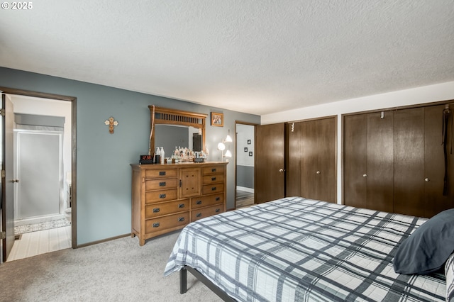 642 SW Cherry Park Rd, Troutdale, OR 97060 - bedroom featuring two closets, a textured ceiling, light carpet, and ensuite bathroom