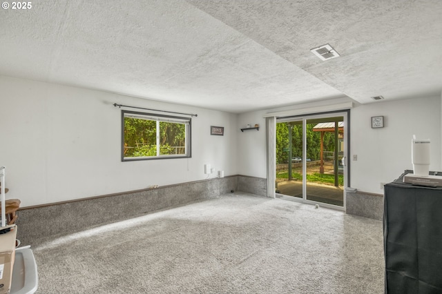 642 SW Cherry Park Rd, Troutdale, OR 97060 - unfurnished living room with a textured ceiling and plenty of natural light