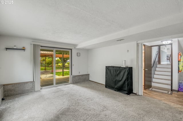 642 SW Cherry Park Rd, Troutdale, OR 97060 - unfurnished living room with a textured ceiling, stairway, and carpet flooring