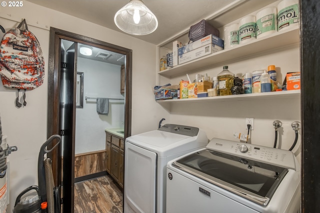 642 SW Cherry Park Rd, Troutdale, OR 97060 - washroom featuring independent washer and dryer, dark wood-type flooring, and cabinet space