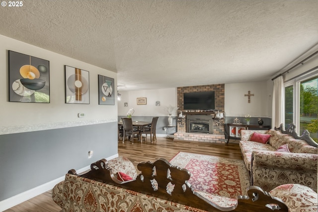 642 SW Cherry Park Rd, Troutdale, OR 97060 - living room with wood finished floors, a textured ceiling, and a brick fireplace