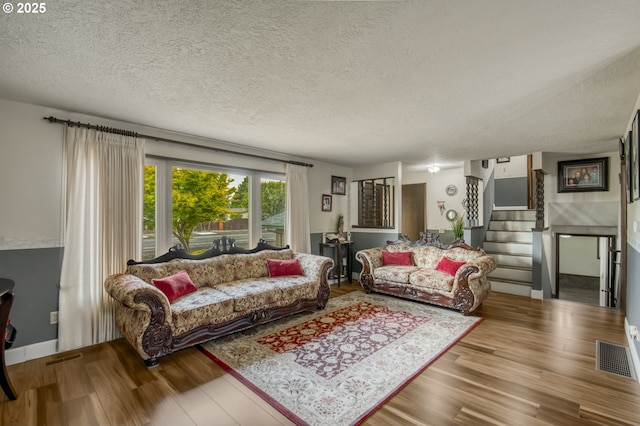 642 SW Cherry Park Rd, Troutdale, OR 97060 - living area featuring wood finished floors, a textured ceiling, and stairs