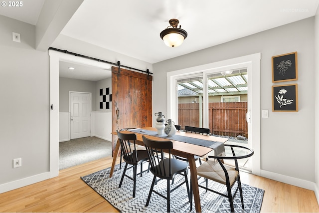 2338 NE 137th Ave, Portland, OR 97230 - dining area featuring a barn door and light wood-type flooring