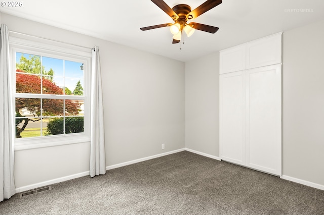 2338 NE 137th Ave, Portland, OR 97230 - unfurnished bedroom with dark carpet, multiple windows, a closet, and ceiling fan
