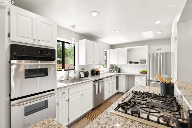2338 NE 137th Ave, Portland, OR 97230 - kitchen with stainless steel appliances, tasteful backsplash, white cabinets, open shelves, and recessed lighting