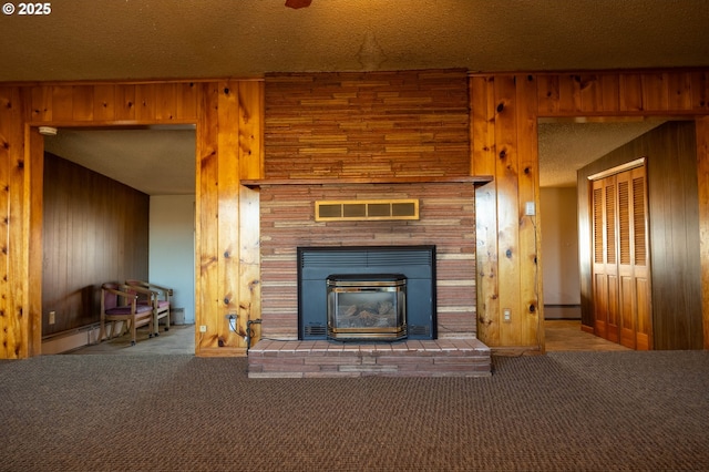 interior space featuring a textured ceiling, carpet floors, visible vents, and wooden walls