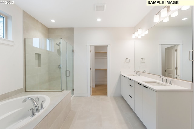 bathroom featuring vanity, tile patterned flooring, and shower with separate bathtub