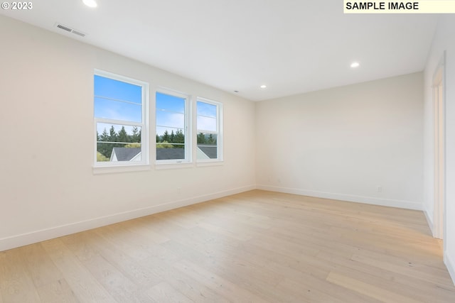 spare room featuring light wood-type flooring