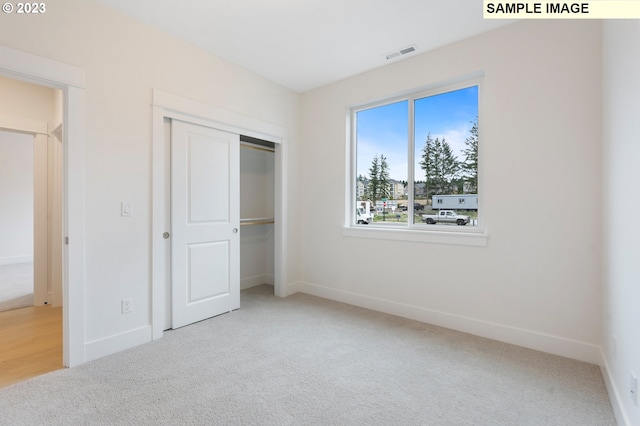 unfurnished bedroom featuring a closet and carpet