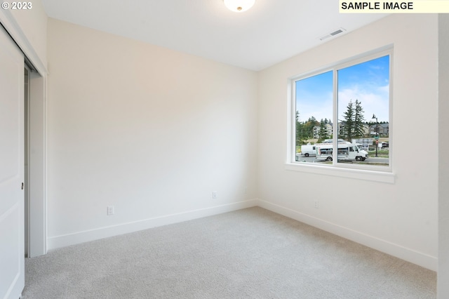 unfurnished bedroom featuring a closet and carpet flooring