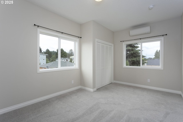 9638 SE Holgate Blvd Unit 1, 2, 3, Portland, OR 97266 - unfurnished bedroom featuring baseboards, a wall unit AC, a closet, and carpet flooring
