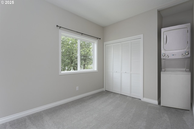 9638 SE Holgate Blvd Unit 1, 2, 3, Portland, OR 97266 - unfurnished bedroom featuring baseboards, stacked washer and clothes dryer, carpet floors, and a closet