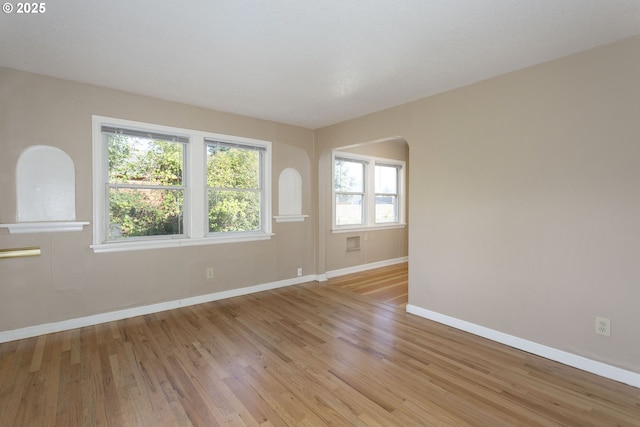 9638 SE Holgate Blvd Unit 1, 2, 3, Portland, OR 97266 - unfurnished room with baseboards, arched walkways, and light wood-style flooring