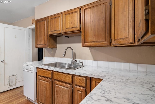 9638 SE Holgate Blvd Unit 1, 2, 3, Portland, OR 97266 - kitchen featuring light countertops, brown cabinets, dishwasher, a sink, and light wood-type flooring