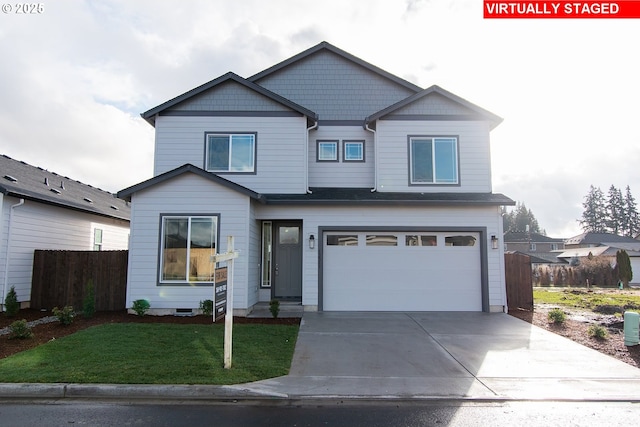 view of front of house featuring a front yard and a garage