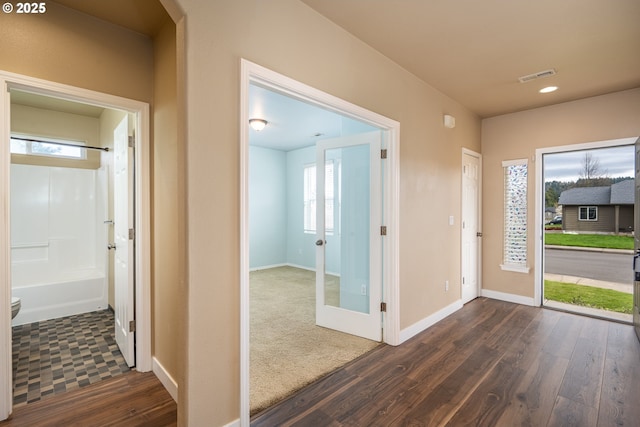 corridor featuring visible vents, baseboards, recessed lighting, and dark wood-style floors