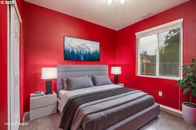 bedroom with visible vents and baseboards