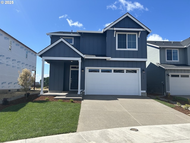5954 Henshaw St SE, Albany, OR 97322 - view of front facade with concrete driveway, board and batten siding, a garage, and a front lawn